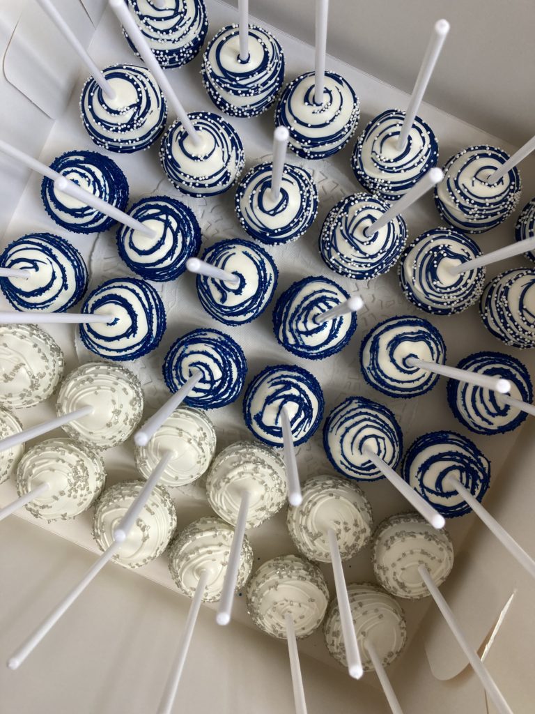 Blue and white cake pops in a box