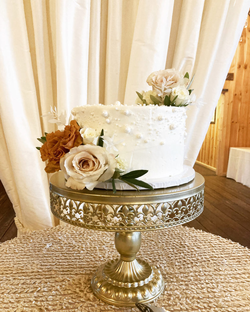 Small white wedding cake with pearls