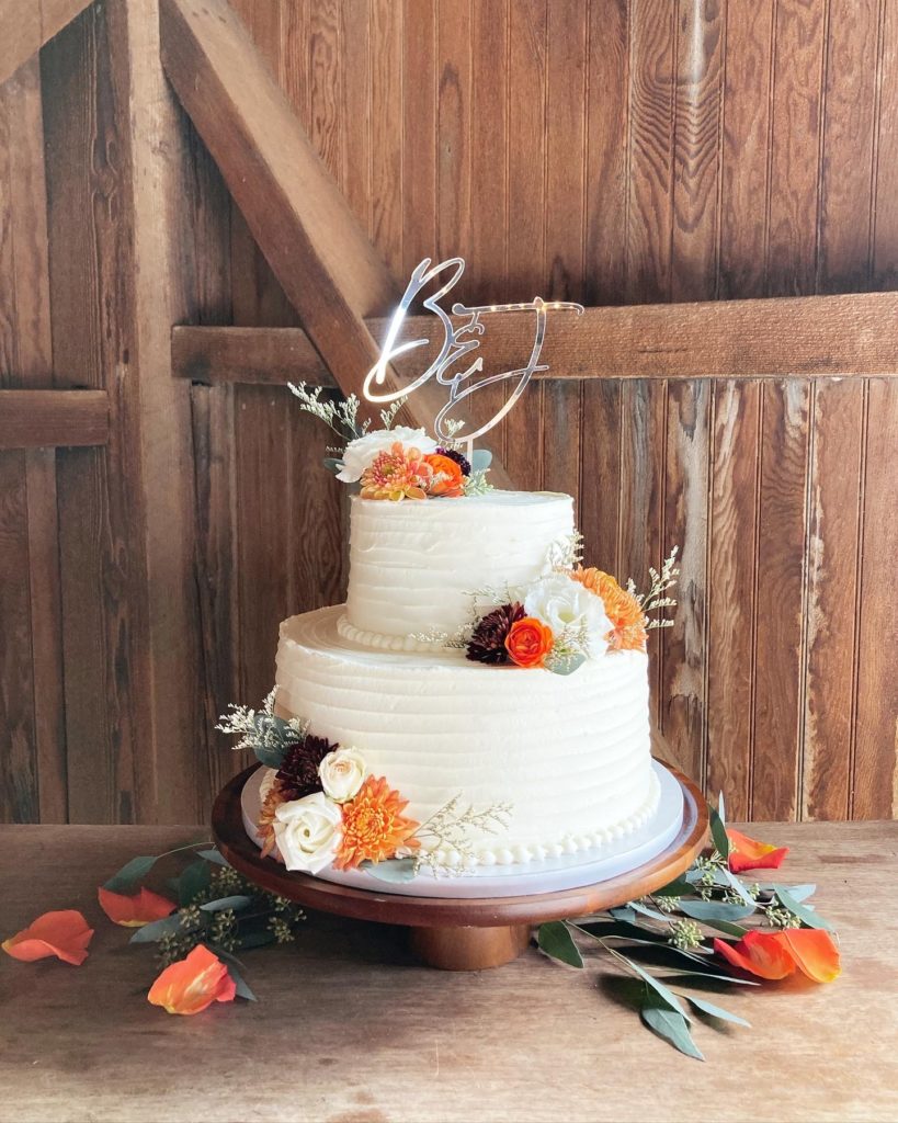 Rustic fresh flower fall wedding cake in a barn